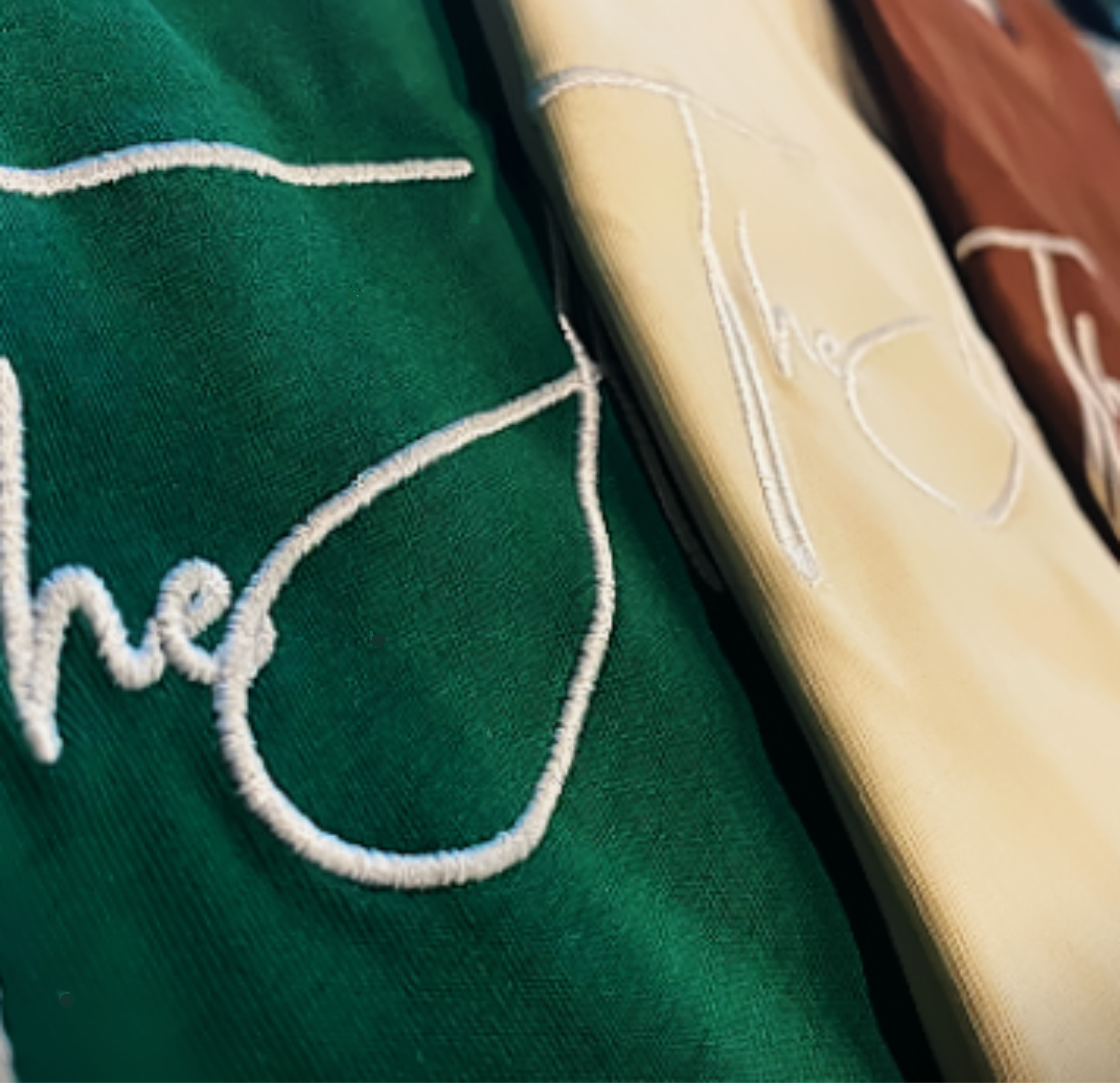 Close-up of The Meek Collection t-shirts by THE ARMOR OF GOD™ in Hunter Green Cream and Brown showing detailed embroidery and premium fabric texture.