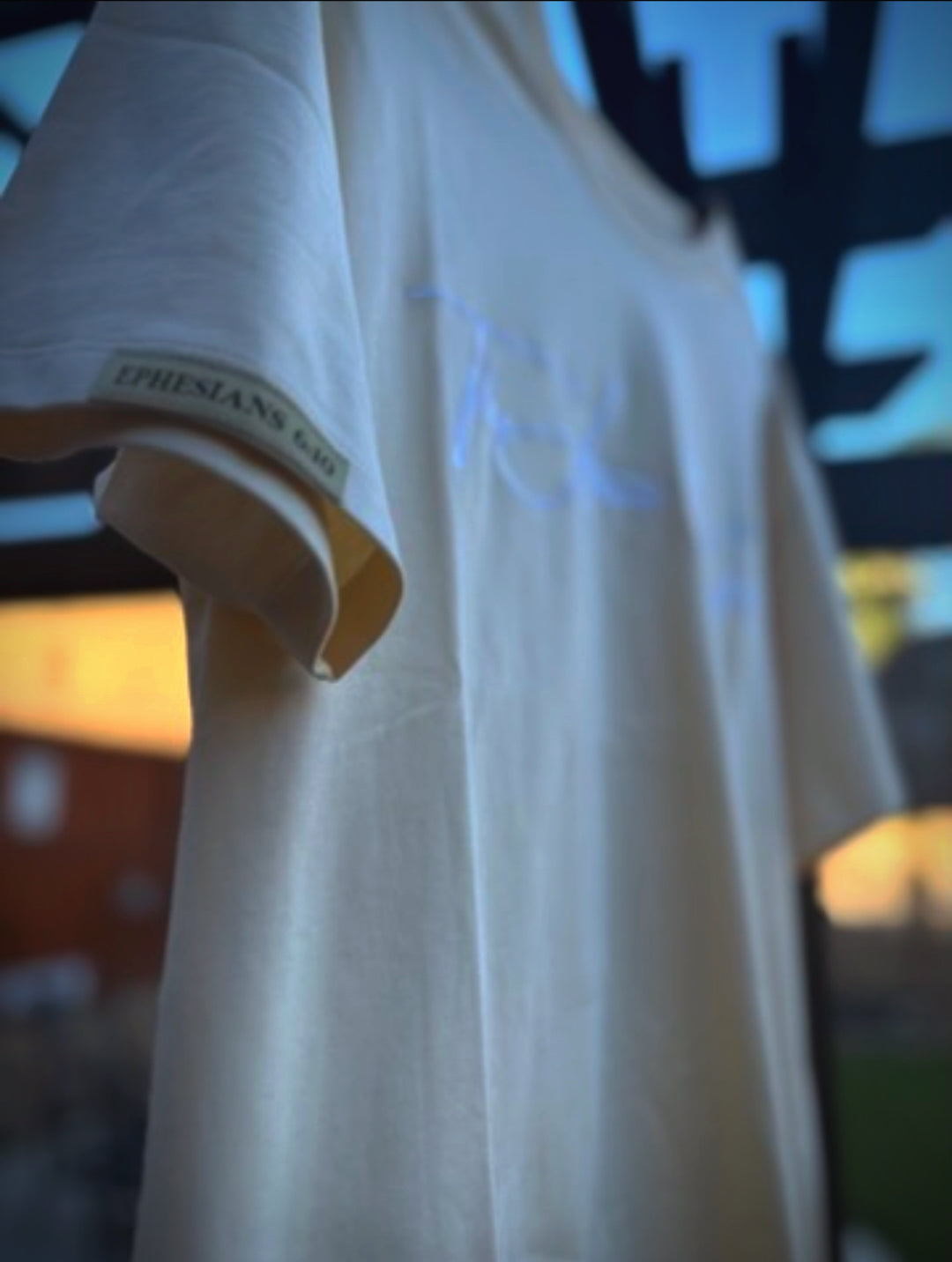 Cream t-shirt with text on a blurred background